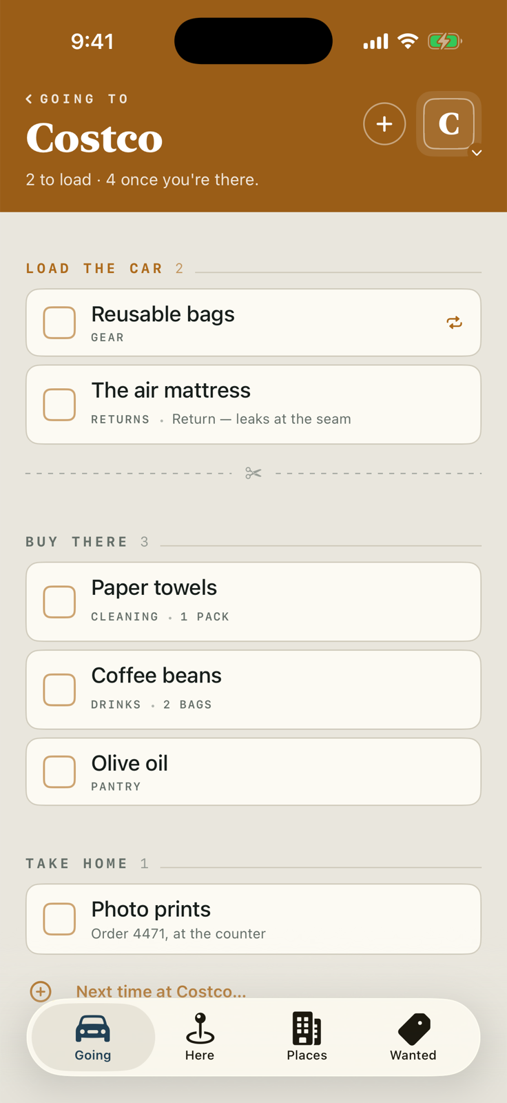 The Going slip for Costco in Bring Buy Get: a marigold header reading Going to Costco, a Load the Car section with reusable bags and an air mattress return, a dashed tear line with scissors, then Buy There with paper towels, coffee beans and olive oil, and Take Home with a photo prints order.